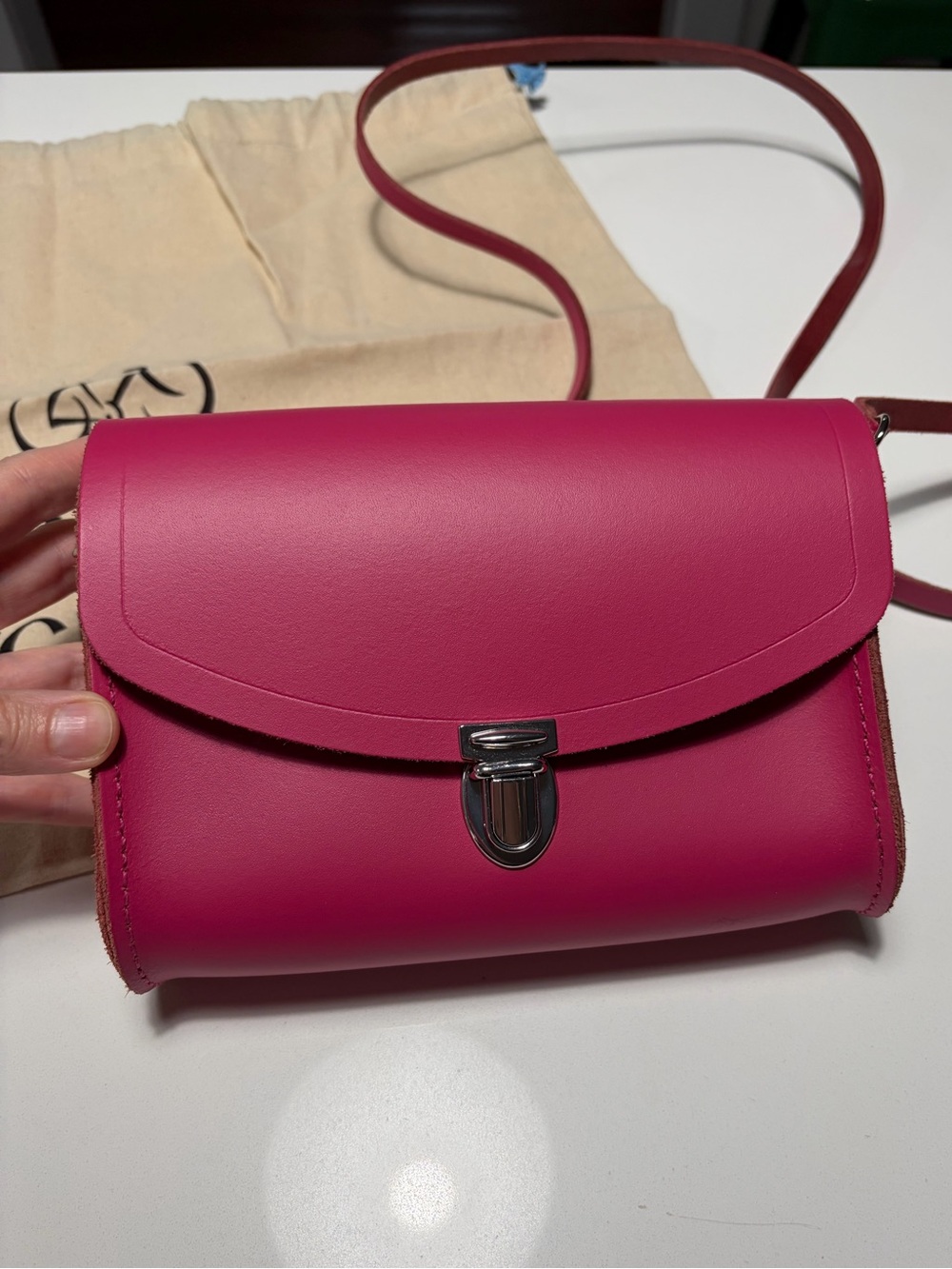 NWOT Cambridge Satchel Company bright pink crossbody/clutch and dust bag.